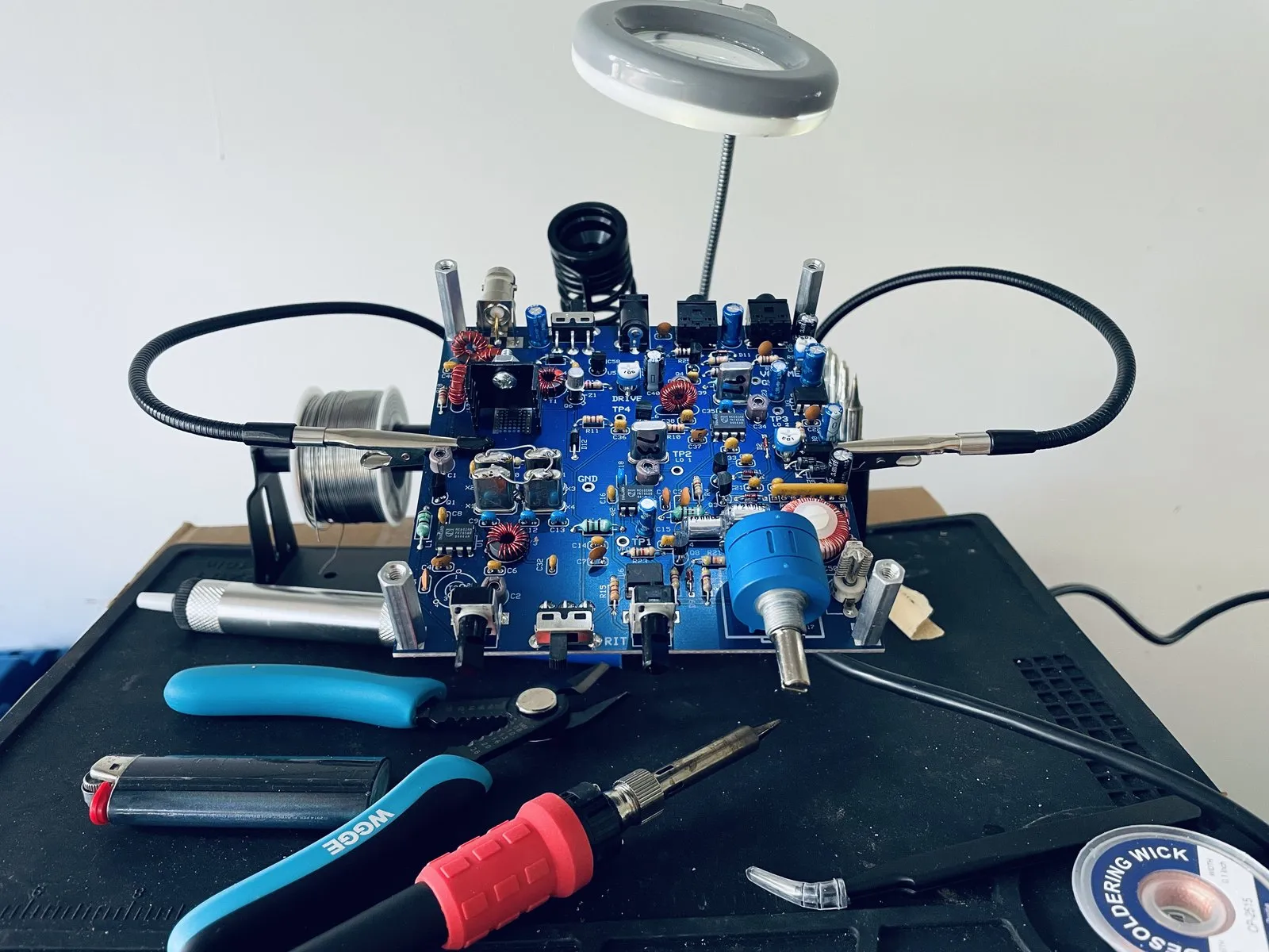 A NorCal 40B kit from NM0S Electronics mid-build, held in a helping-hands clamp on the bench.